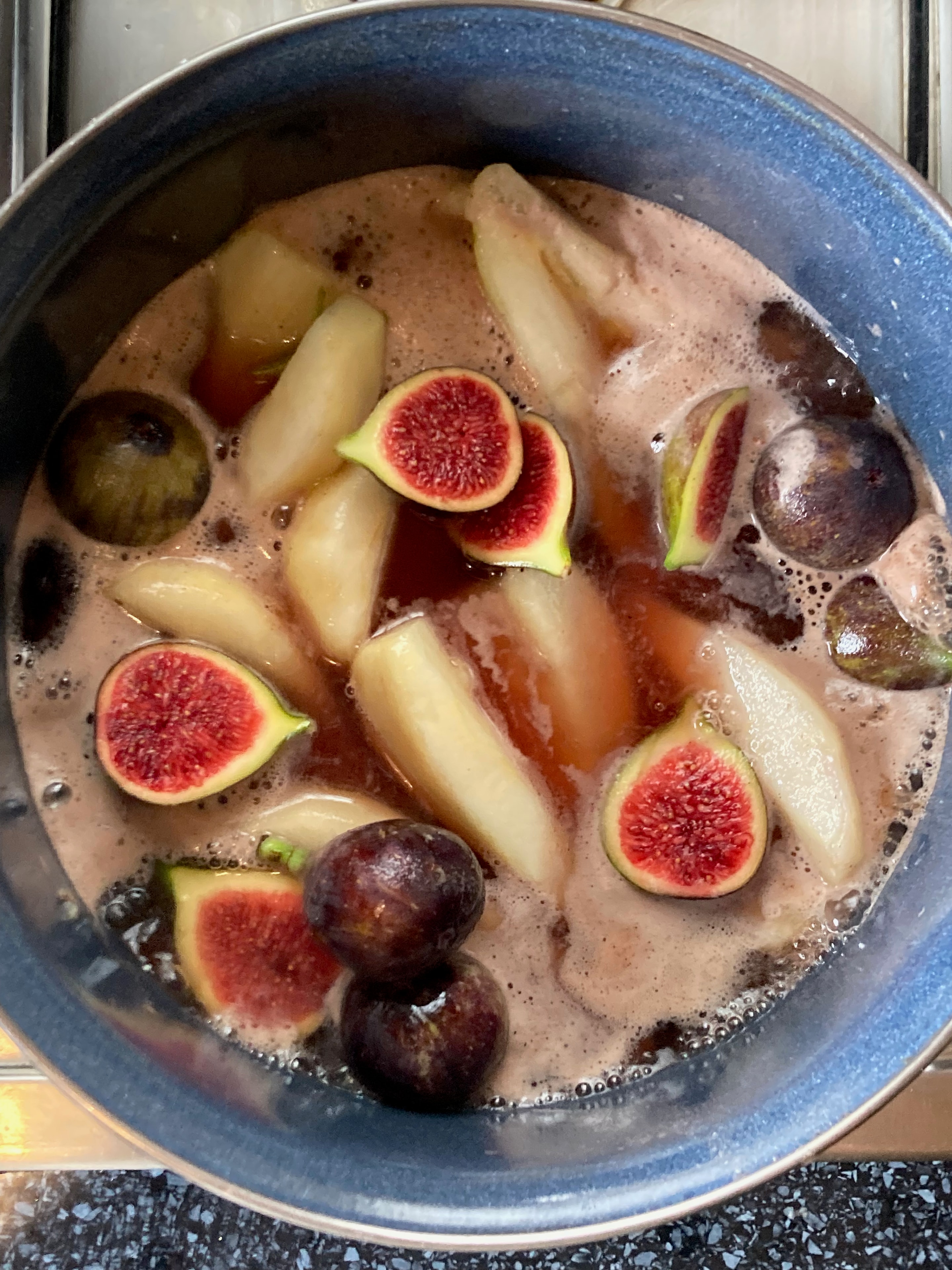 Figs and pears poaching in a pot