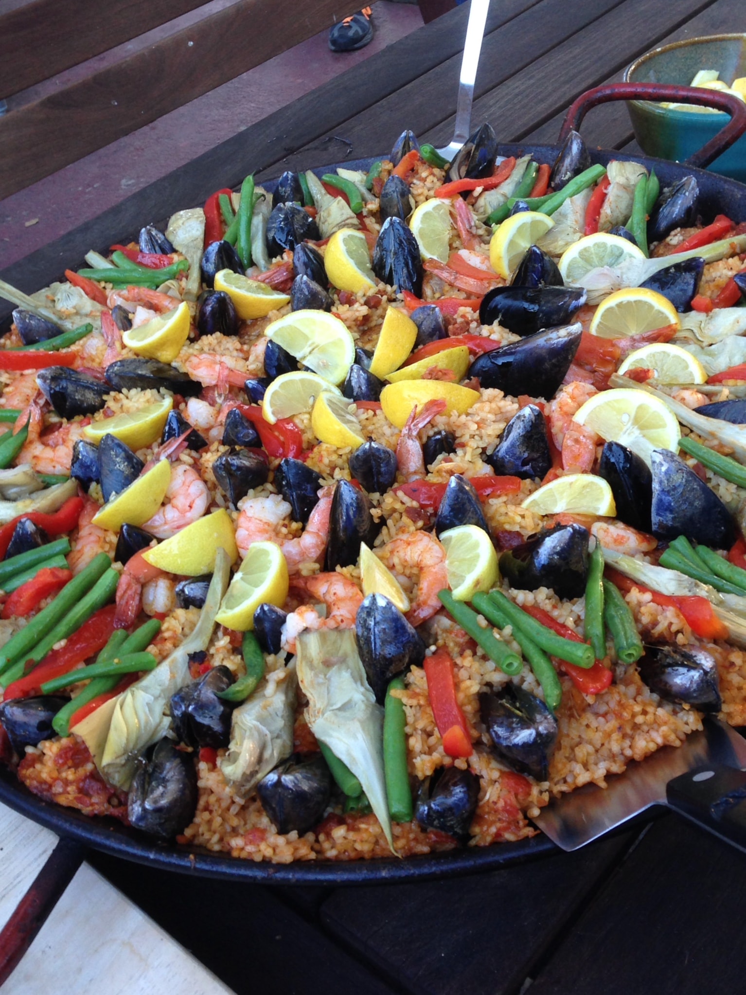 Paella with mussels, shrimp, peppers, and lemon